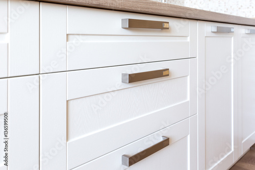 Close-up of white wooden facade of a traditional style kitchen 