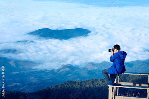 Traveller man shoot over the cloud on terrace hill at Kew Mae Pan Doi Inthanon, chiangmai, Thailand
