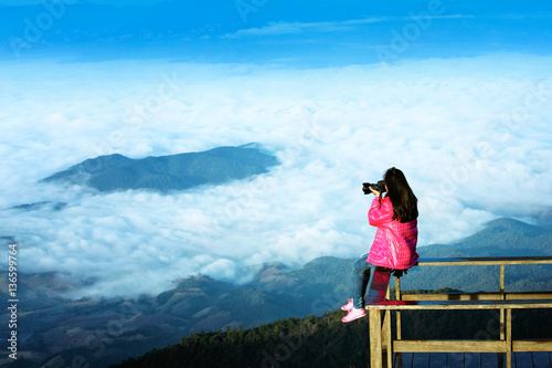 Traveller woman shoot over the cloud on terrace hill