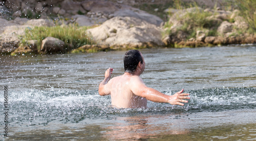 a man jumps out of the water