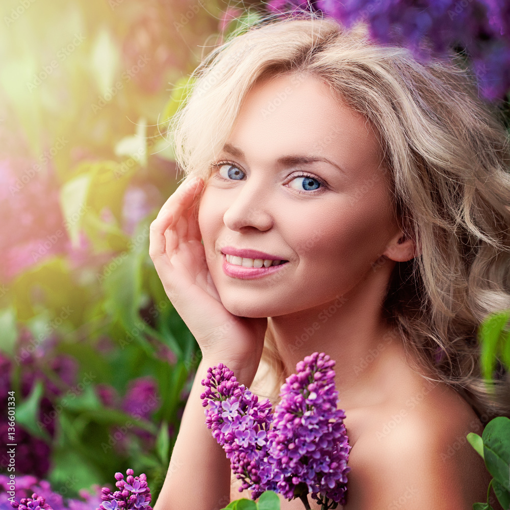 Cute Smiling Woman with Summer Light and Lilac Flowers Outdoors. Cute Smiling Woman with Summer Light and Lilac Flowers Outdoors.