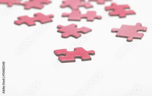 Colorful puzzle pieces on a white surface.