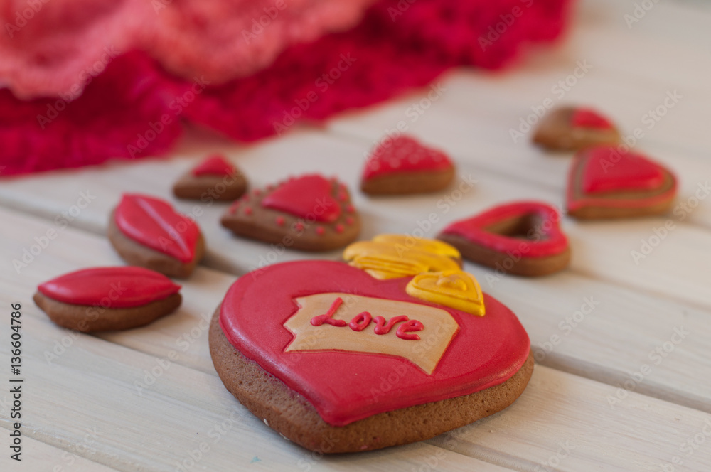 St. Valentines composition. Red glazed honey cakes on wooden table St. Valentines composition. Red glazed honey cakes on wooden table