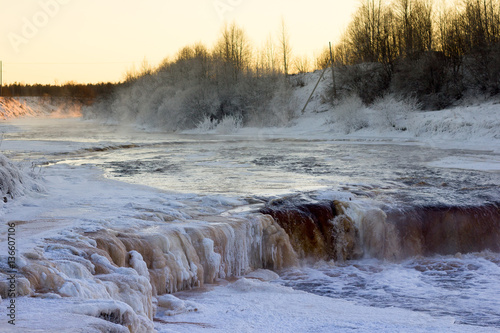 Winter waterfall. Winter landscape with a waterfall at sunset. Sablinsky waterfall. Russia Leningrad region