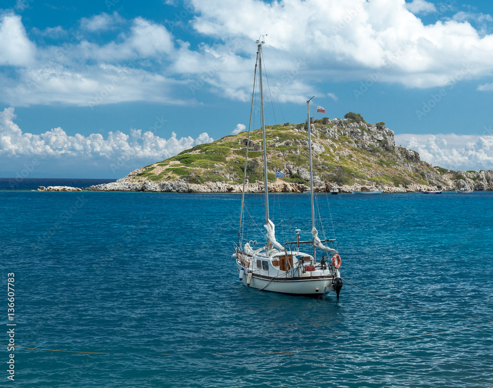 Yacht near island in the Mediterranean sea Yacht near island in the Mediterranean sea
