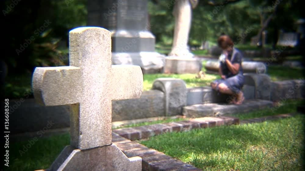 woman crying in a cemetery.