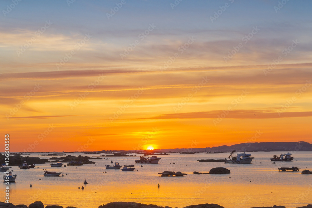 Boats anchored at sunset