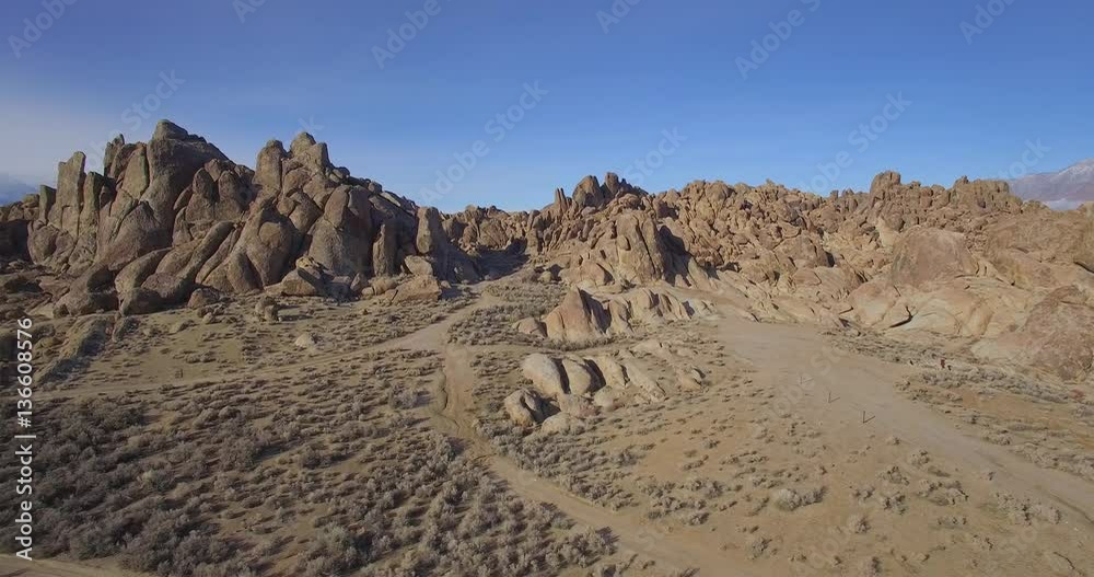 Boulder Rocks Desert Sideways / Aerial sideways flight in a desert with rock boulders on a clear day. Boulder Rocks Desert Sideways / Aerial sideways flight in a desert with rock boulders on a clear day.
