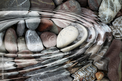Canvas Print Water ripples over the stone pebbles