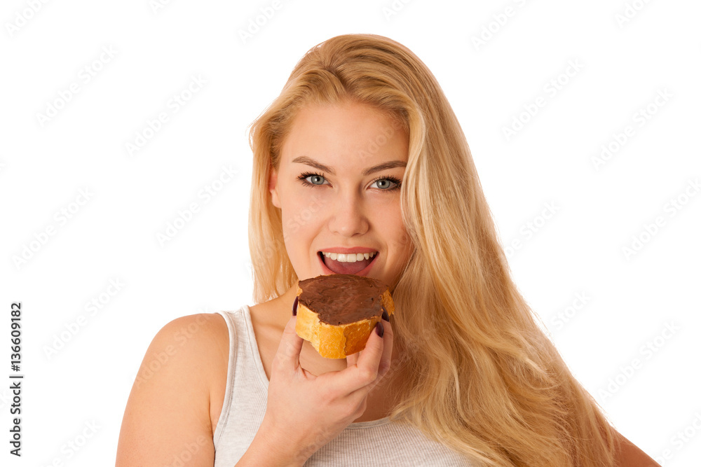 Young blond woman eating breakfast bread and nougat spread isola Young blond woman eating breakfast bread and nougat spread isola