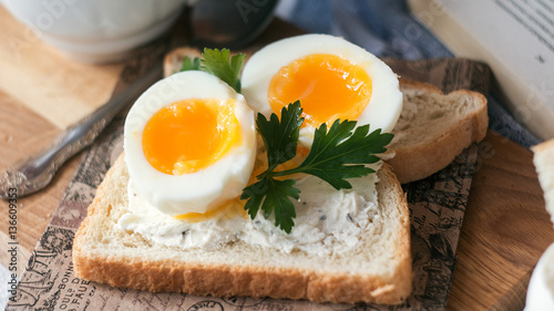 freshly boiled white egg on wooden board. Healthy fitness breakfast