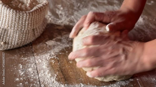 Woman hands kneading the bread dough - closeup, slow slide