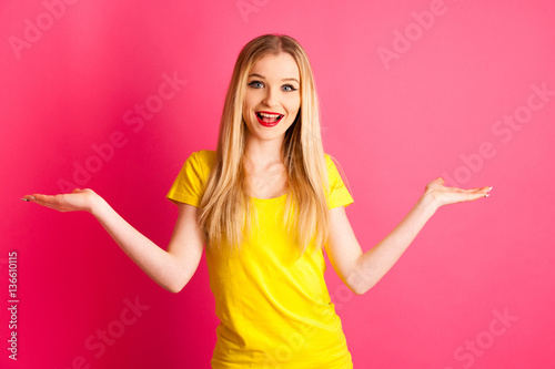 excited young woman over pink background gesture success with ar