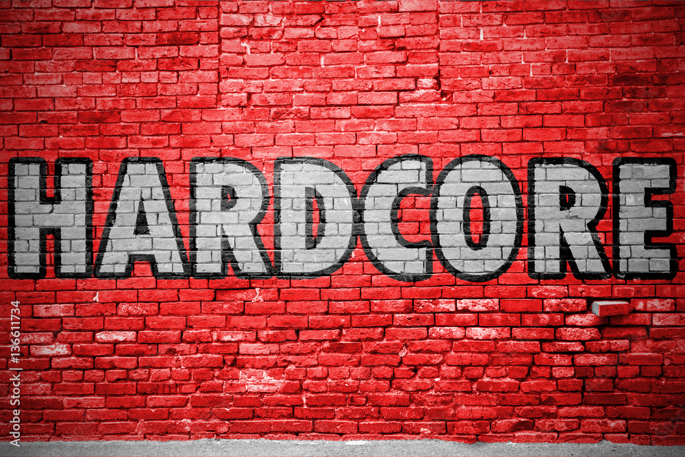 Fototapeta premium Hardcore Ziegelsteinmauer Graffiti