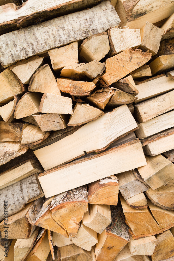 Firewood background - chopped firewood on a stack. Dry chopped firewood logs in a pile. Nature abstract background with stack of firewood. Firewood background - chopped firewood on a stack. Dry chopped firewood logs in a pile. Nature abstract background with stack of firewood.