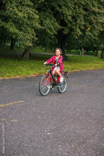 Girl child 10 years old on a Bicycle in the Park. © Svitlana