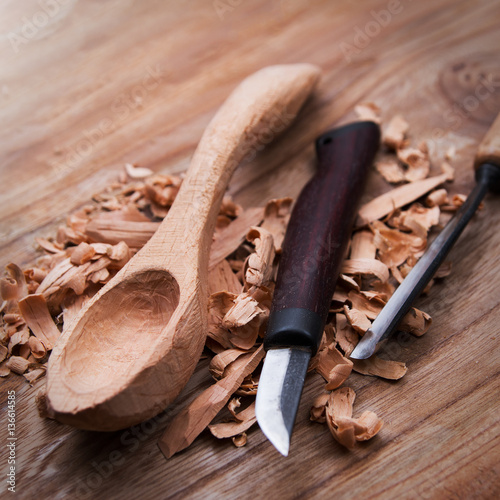 Wooden spoon with carvin tools photo