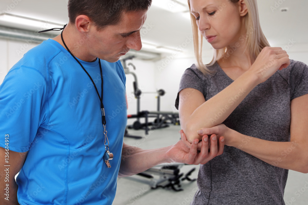 Fototapeta premium Sport Woman with elbow pain in Gym . Sports exercising injury.