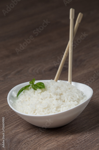 White rice in ceramic bow with wooden sticks