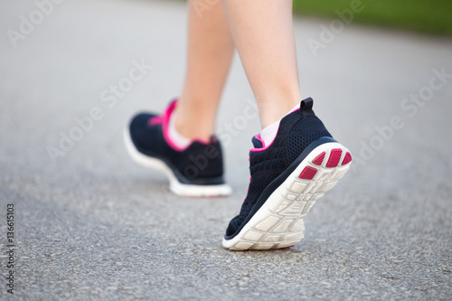 Sporty woman running on the road. Fitness and workout wellness c