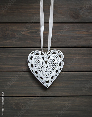 Heart shape ornament on wooden background