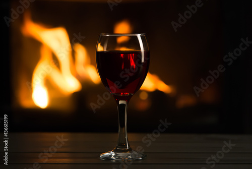 Glass of wine in front of fireplace