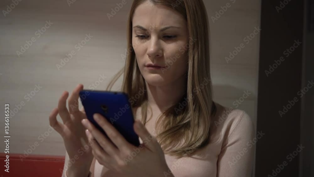 Beautiful young woman using her smartphone in a cafe. Browsing internet, communicating with friends. Beautiful young woman using her smartphone in a cafe. Browsing internet, communicating with friends.