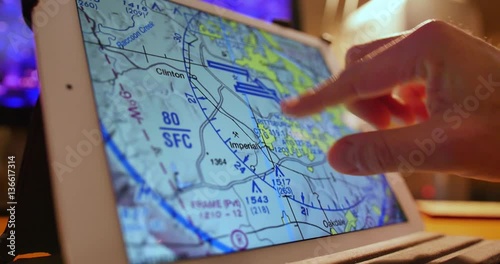 A pilot examines VFR maps of the Pittsburgh area on a tablet PC before a flight.
 photo