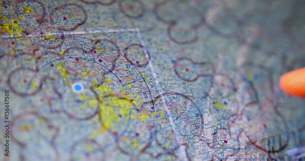 An extreme closeup shot of a pilot examining VFR maps of the North American east coast on a tablet PC before a flight.
