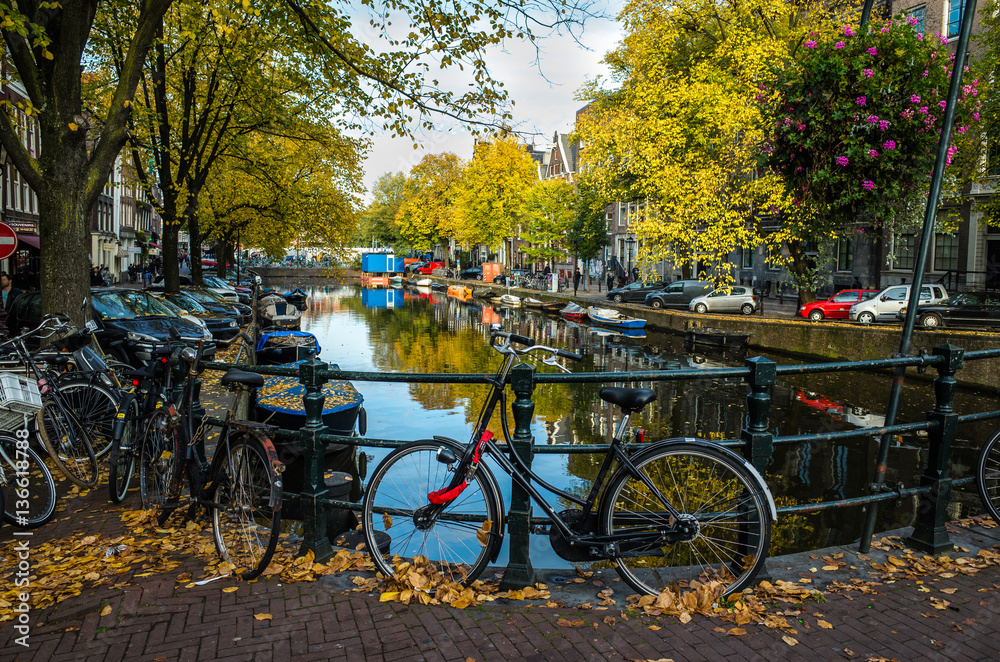 Parked bicycles near canal in Amsterdam, Netherlands