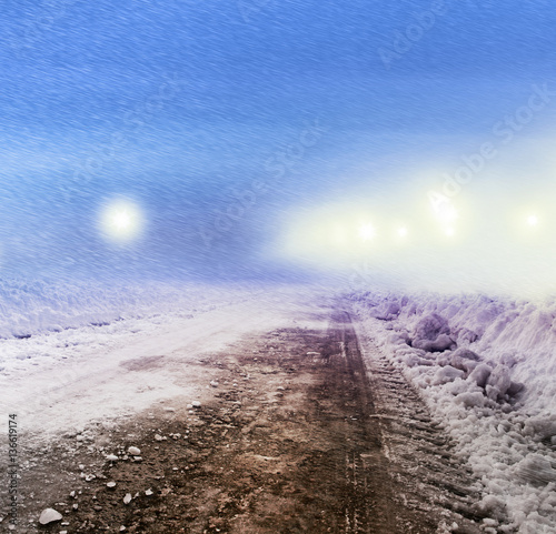 Snow covered road at night photo