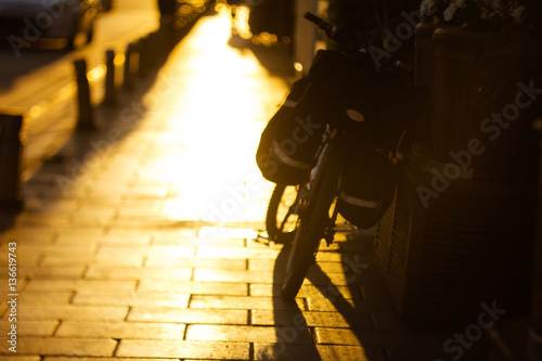 Blurred bicycle on the road in warm sunny light
