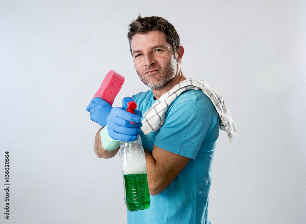man smiling happy doing house cleaning holding spray bottle and sponge man smiling happy doing house cleaning holding spray bottle and sponge