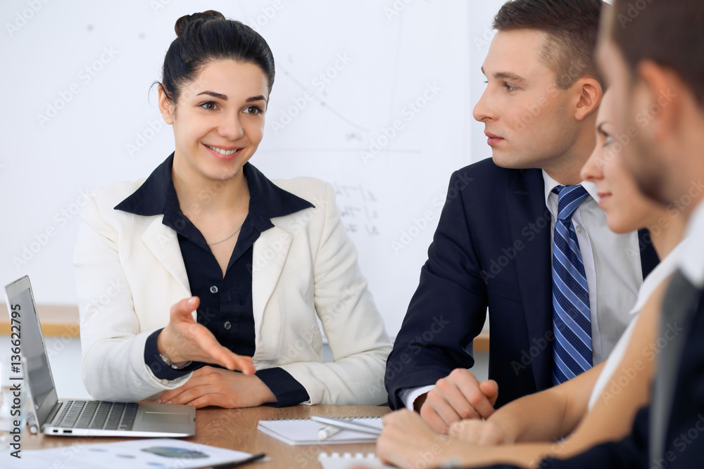 Group of business people and lawyers discussing contract papers at meeting Group of business people and lawyers discussing contract papers at meeting