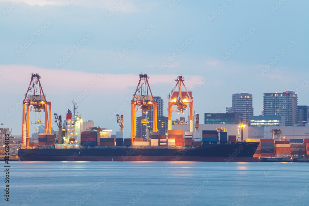Fototapeta premium Cargo freight ship with stacked container at harbor terminal