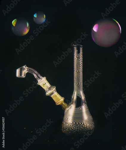 Dabbing glass rig with soap bubbles floating - isolated over bla