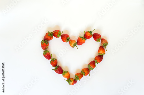 Strawberry heart-shaped arrangement.On white background