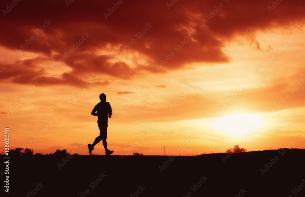 Silhouette a man is running in sunset time