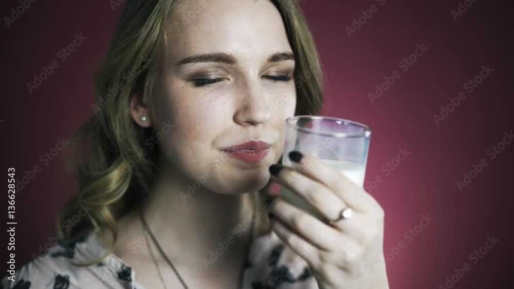 Woman enjoying fresh glass of milk. Close up locked down shot. Woman enjoying fresh glass of milk. Close up locked down shot.