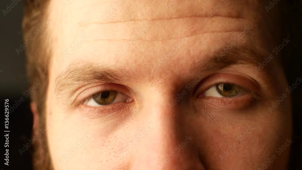 Close the eyes of a young white man with curly hair plan. He blinks and moves his head back Close the eyes of a young white man with curly hair plan. He blinks and moves his head back