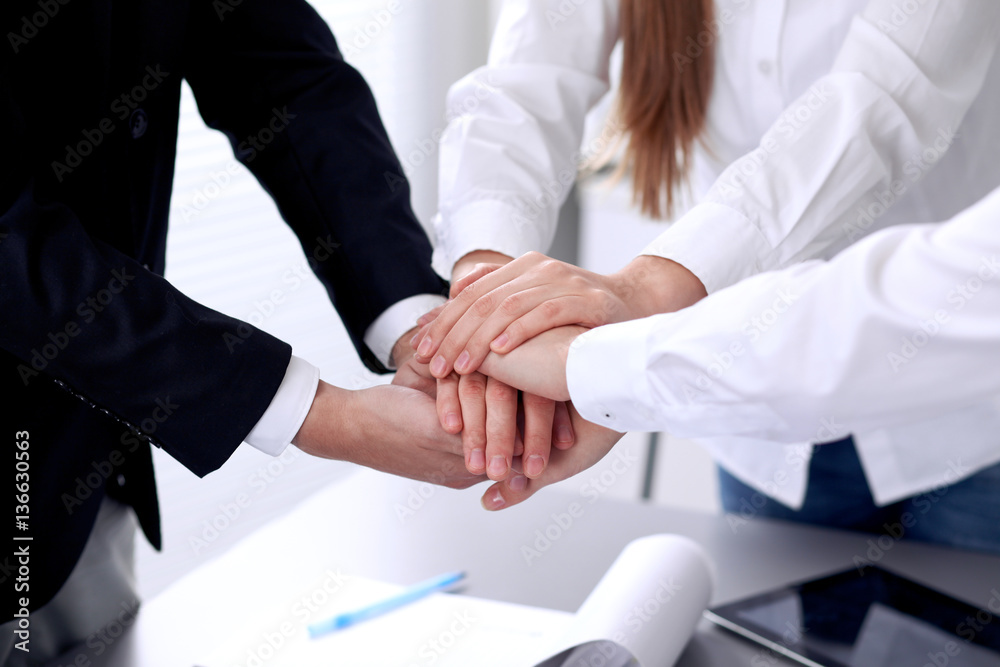 Business people with their hands together in a circle Business people with their hands together in a circle