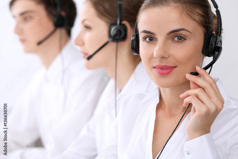 Call center. Focus on beautiful woman in headset Call center. Focus on beautiful woman in headset