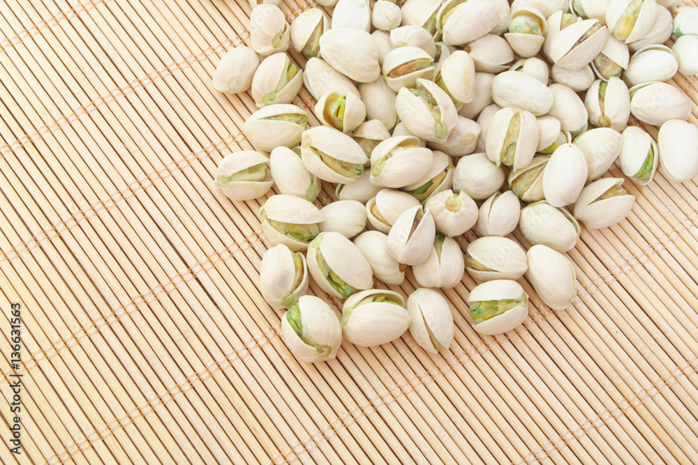 Pistachio nuts on bamboo background