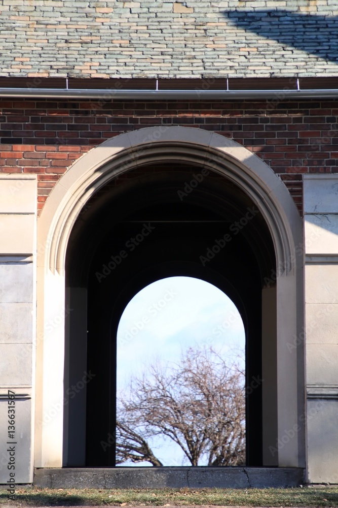 Double Archway with view of trees in background during winter.