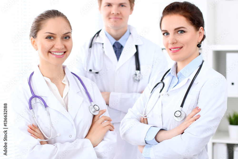 Happy female doctor with medical staff at the hospital. Successful team at health care concept Happy female doctor with medical staff at the hospital. Successful team at health care concept