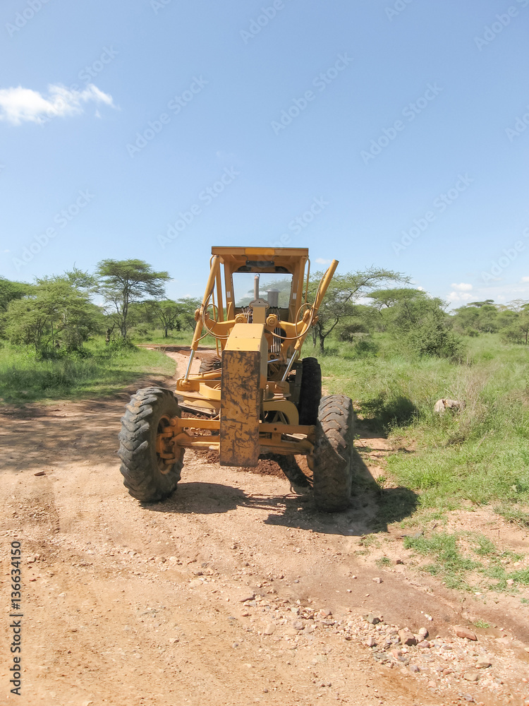 Wheeled grader stands on dirt road in sacvanna. Serengeti National Park, Tanzania, Africa.
Wheeled grader stands on dirt road in sacvanna. Serengeti National Park, Tanzania, Africa.