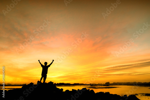 silhouette man Happy celebrating winning success at sunset © sutadimages