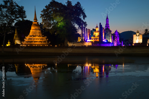 View of the ruins of the ancient Buddhist temple Wat Mahathat in the festive lighting. Sukhothai, Thailand