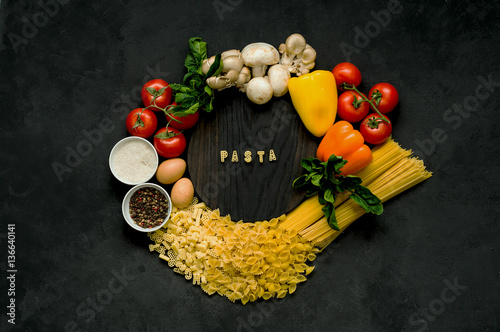 Ingredients for pasta on a black background.