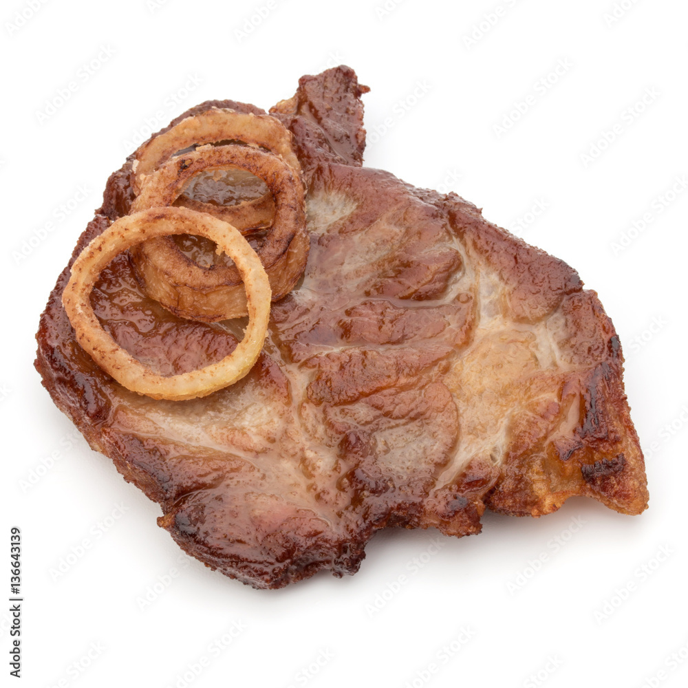 Cooked fried pork meat with onion slices garnish isolated on whi Cooked fried pork meat with onion slices garnish isolated on whi